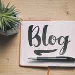 The word "blog" on a paper with a pen and small cactus to represent how important blogging is for therapists and private practice owners working on their search engine optimization.