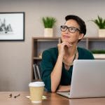 Shows a woman thinking. Represents how you can boost your SEO during downtime in the pandemic.