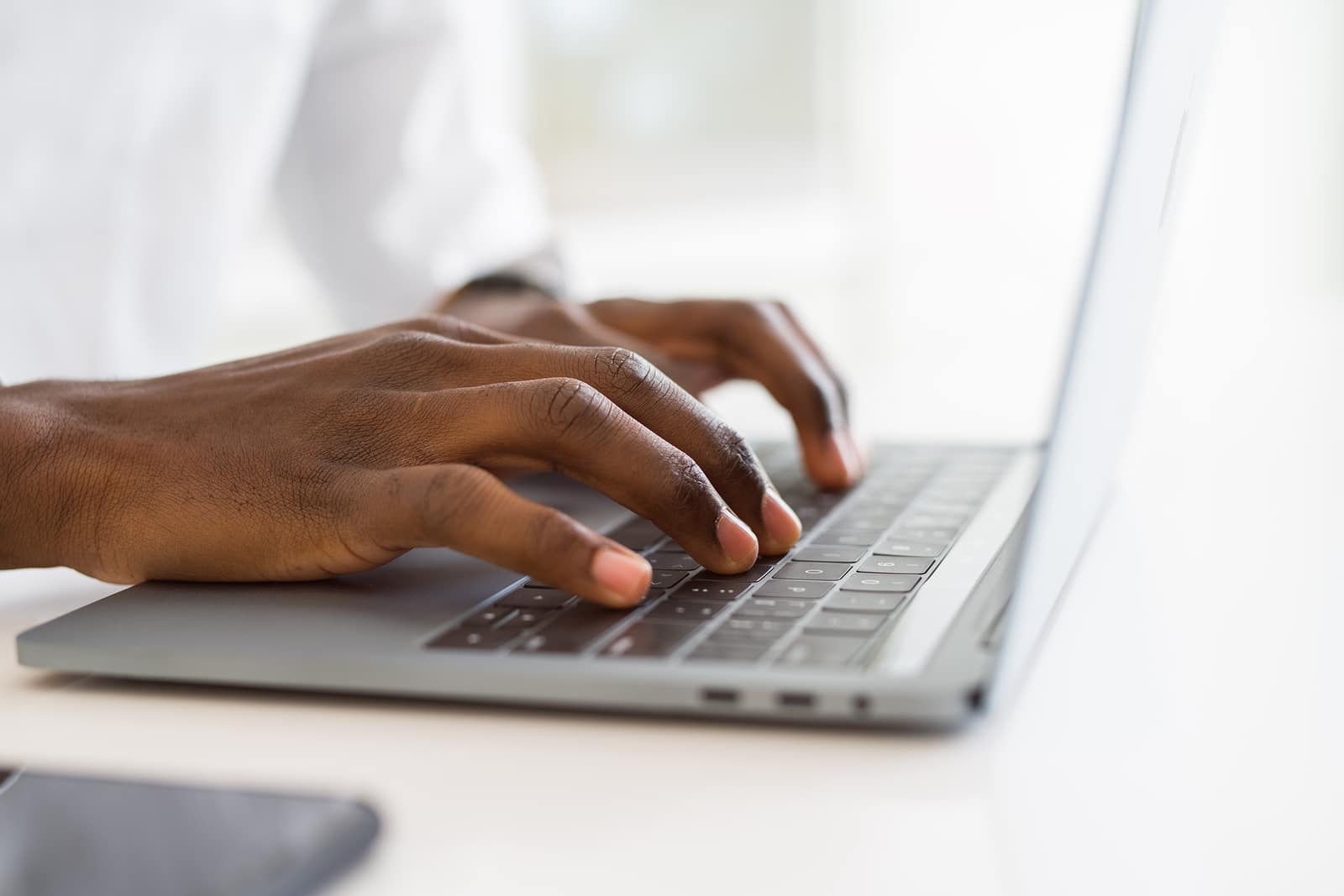 Man doing keyword research for business on silver laptop. If you're looking for the best mental health keywords, you've come to the experts. Counseling keywords can be difficult to get just right. That's why we are so meticulous in choosing the best keywords for your clients.