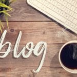 Blog text with computer keyboard, cup of coffee and plant pot. Represents the value of blogging for SEO when you are a speech therapist in private practice.