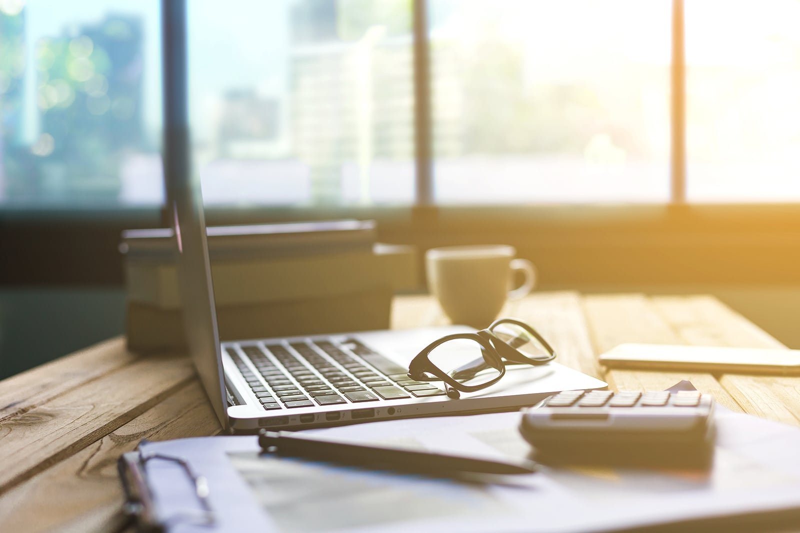 Office desk table of modern workplace with laptop on wooden table. Simplified SEO Consulting can support your site with online seo training. Contact us for SEO consulting services today.