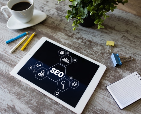 Table in wooden table near coffee and plant. SEO for mental health professionals is very important to get your people, but ethical seo is a must. Learn how optimizing SEO for backlinking can help you build credible traffic to your website.