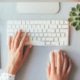 A person types on a laptop. They are blogging for seo.