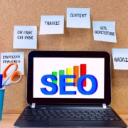 computer with the text SEO with seo keywords around it. Learn about optimizing your website from an seo specialist