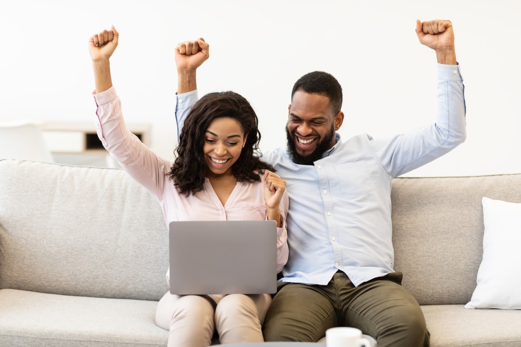 Two individuals cheering with their arms in the air while working on a laptop together. Are you ready to optimize your own site? Discover how our online DIY SEO courses can help you!