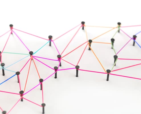 yarn linking pins together like a web. Represents how links can help boost your SEO and direct your audiences attention
