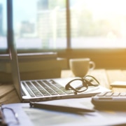 A set of glasses rest on a laptop as the morning sunlight pours through the window. This could represent SEO strategies for private practice owners. Contact Simplified SEO Consulting for DIY seo for small businesses.