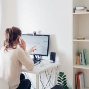 Woman at a computer screen wondering how to incorporate SEO Keywords easily