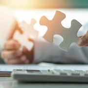 A person holds two puzzle peices representing the challenges of navigating Google My Business in counseling. Learn more about improving local SEO for therapists and more by contacting Simplified SEO consulting.