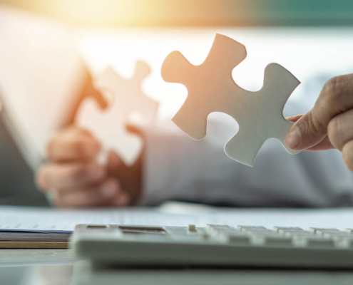 A person holds two puzzle peices representing the challenges of navigating Google My Business in counseling. Learn more about improving local SEO for therapists and more by contacting Simplified SEO consulting.