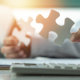 A person holds two puzzle peices representing the challenges of navigating Google My Business in counseling. Learn more about improving local SEO for therapists and more by contacting Simplified SEO consulting.