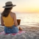 Woman blogging on the beach during a Carnival Liberty cruise for SEO cruise to learn how to do blogging for therapists in Florida and throughout the United States.