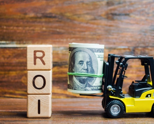 Photo of a toy car holding a roll of bills next to the word "ROI". This photo represents how seo coaching can help therapists learn seo marketing and get a great ROI.