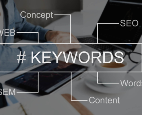 Image of someone working on a laptop with the word keyword. Discover how you can find your ideal clients with the help of keyword research.