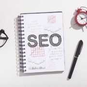A book with SEO written on it on a table. Looking to improve your healthcare SEO but don't know where to start? Our SEO strategy for the healthcare industry can help!