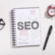 A book with SEO written on it on a table. Looking to improve your healthcare SEO but don't know where to start? Our SEO strategy for the healthcare industry can help!