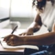 Shows a woman writing a blog for her private practice's website. Symbolizes how Simplified SEO Consulting can give mental health professionals seo private training to help with their SEO.