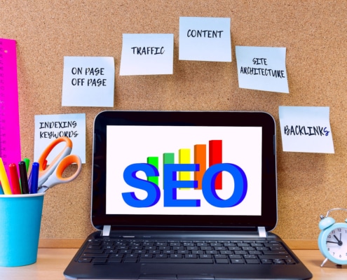 Shows a computer with the word "SEO" with components of it on sticky notes. Represents how seo for private practices can improve with SEO friendly content.