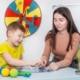 Photo of an SLP providing speech therapy to a young boy. This represents games they might play and a photo an SLP might include on their private practice website. For SEO purposes, it's important to condense photos like I did with this one and choose photos that represent the thing you are discussing such as how this one represents a photo an SLP might actually use on their website and is placed in the blog post where I'm discussing photo optimization for SEO.