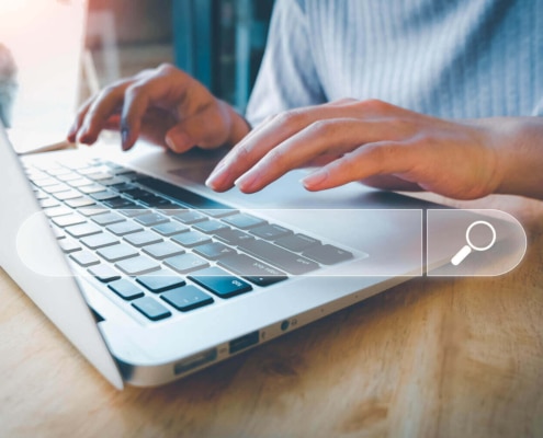 Photo of an individual typing in the search bar on their laptop. Are you interested in improving your Google rankings? Learn how you can improve your Google rankings and start ranking in the Google 3-pack.