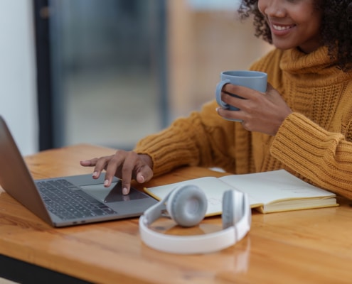 Image of a woman on the computer researching SEO for therapists. If you would like support in doing research for your business, reach out today!