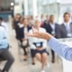 A person speaks in front of a group of business professionals. Want to see how SEO for private practice makes a difference? Speak with our team to learn more ways to do it.