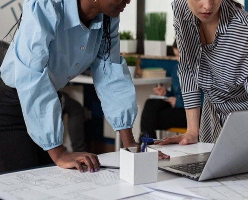 Two women looking at a laptop. Personal injury lawyers can use SEO to build their law firm. Learn more SEO tricks for lawyers here.