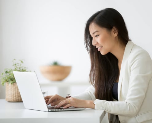 Shows a therapist working on their private practice SEO. Represents how SEO for mental health can support your online therapy site.