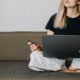 A close up of a woman holding a credit card while on a laptop. This could represent the pros and cons of paid SEO. Learn how to do SEO for therapists for free.