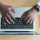 A man typing on a laptop. Representing how you can work on SEO & increase organic traffic on your own. Begin the SEO journey today.