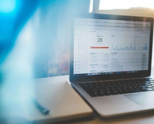 A laptop displaying Google Analytics data, used for tracking SEO & Content performance and improving SEO Writing strategies for better website visibility.
