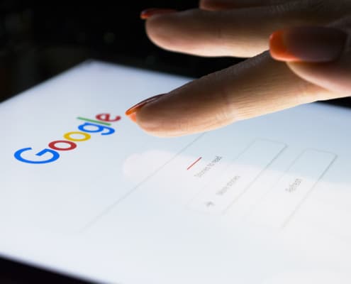 Image of a woman typing on her cell phone clicking on Google. Begin finding your ideal clients with the support of Simplified SEO Consulting.